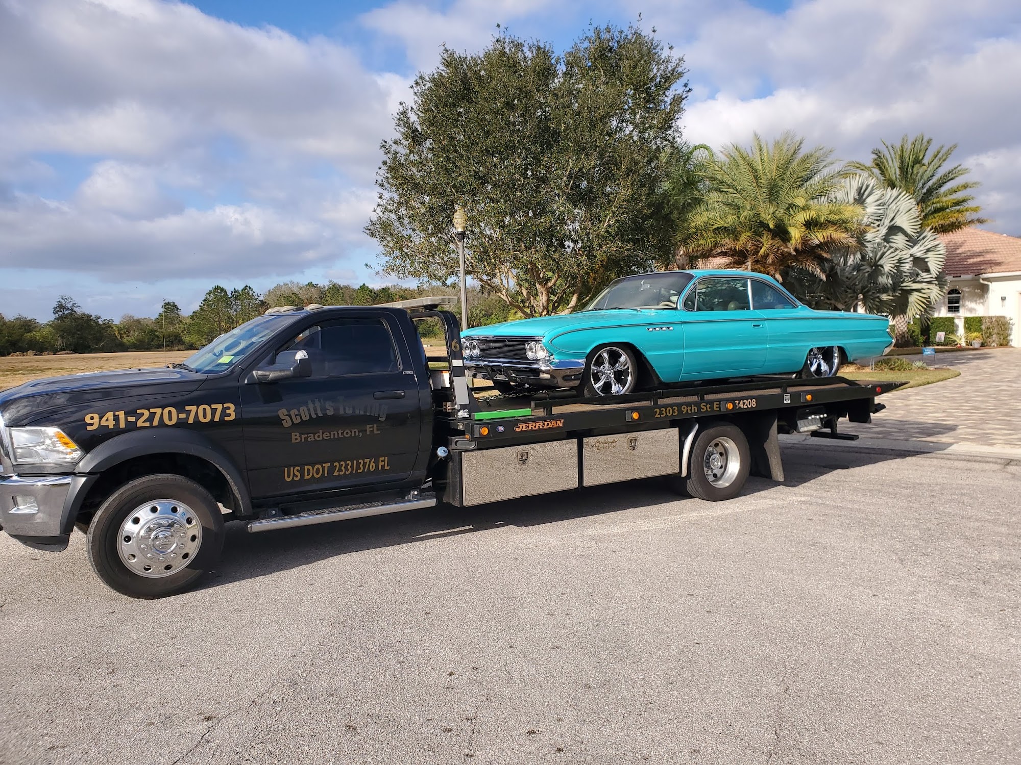 Scott's Towing truck with classic turquoise Buick